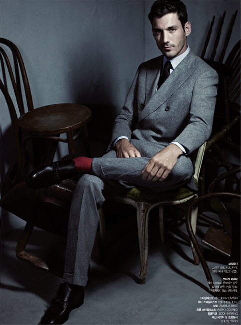 Gentleman Swagger sitting down pink socks, grey suit