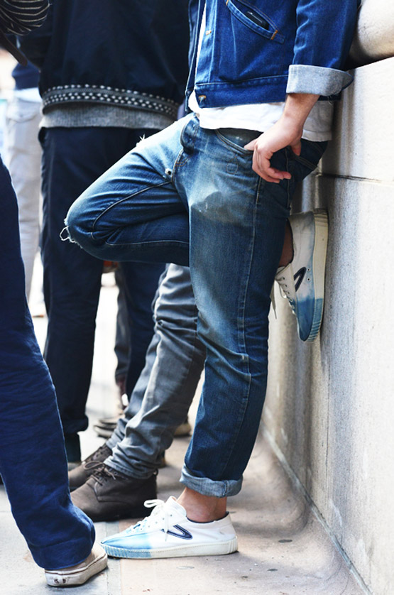 cool-guy-pose-jeans-and-sneakers-posting-up-foot-on-wall