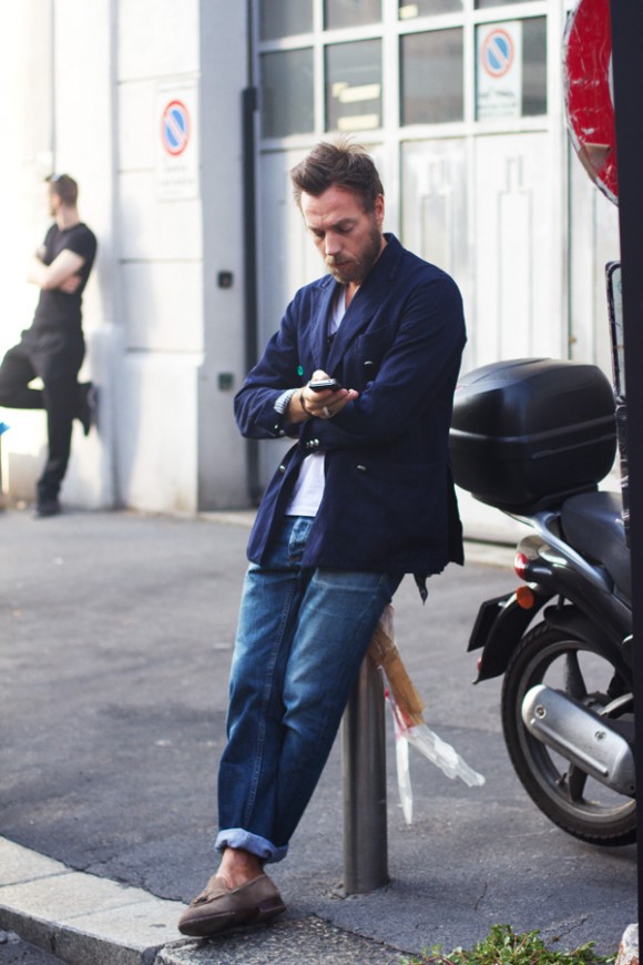 Texting in Milan, posting up looking Cool, cuff jeans & loafers